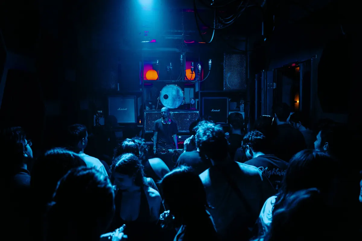 Crowd facing the stage in blue light